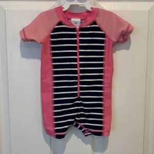 Hanna Andersson pink and navy striped swimsuit and matching hat.